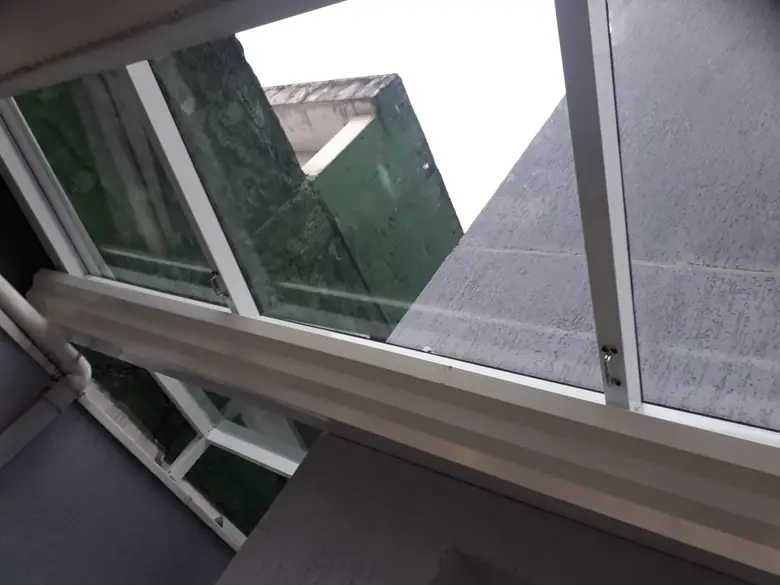 Cobertura de vidro fumê em corredor lateral com esquadria de alumínio